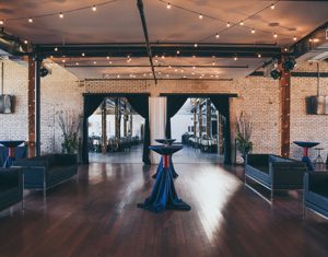 A room with wooden floors and brick walls.